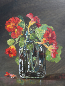 Nasturtiums in a glass bottle